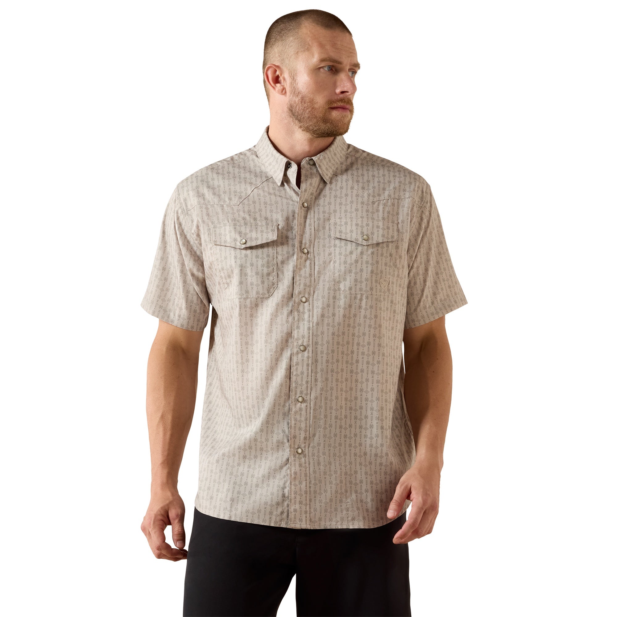Man wearing a patterned short-sleeve shirt on a white background