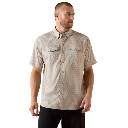 Man wearing a patterned short-sleeve shirt on a white background