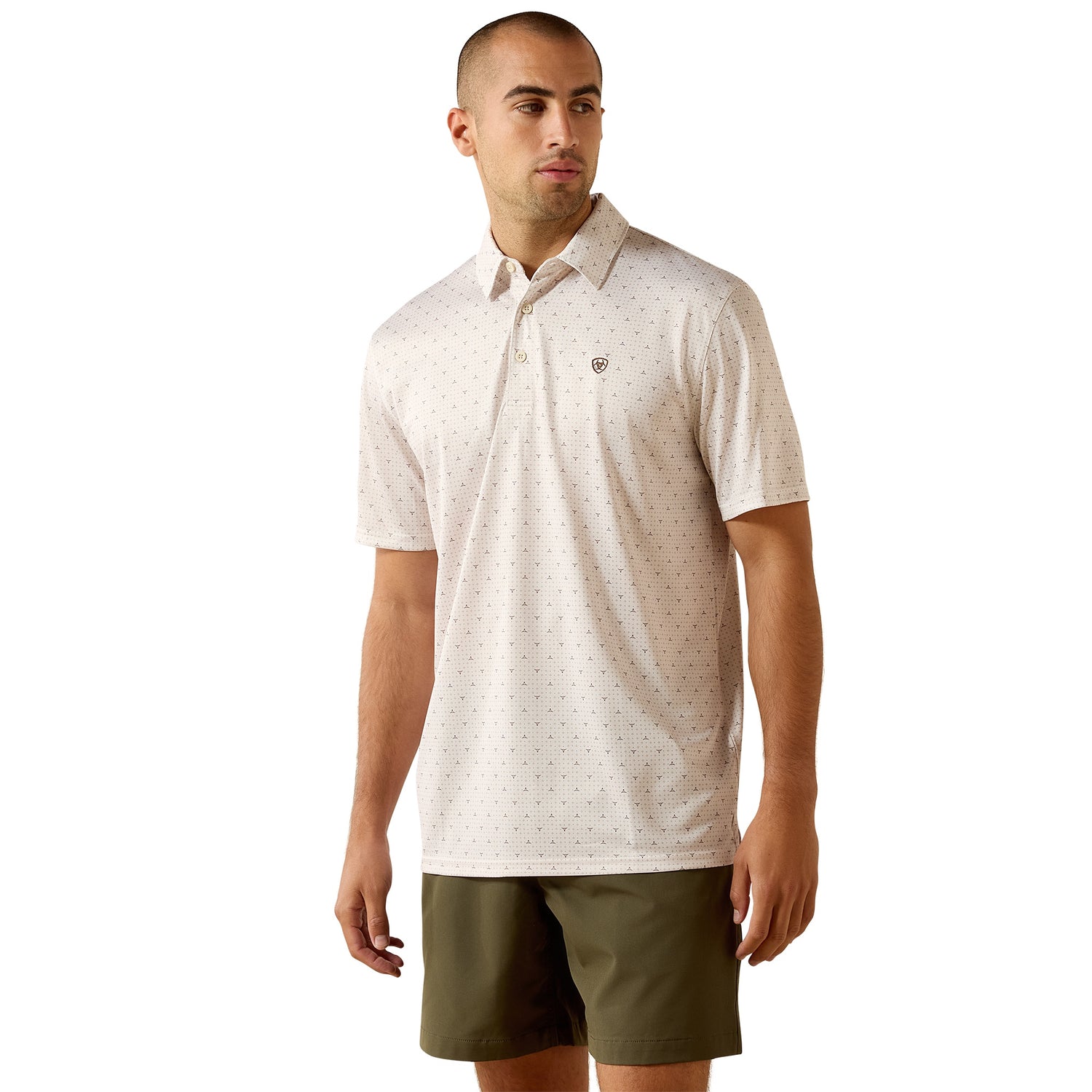Man wearing a patterned polo shirt and green shorts on a white background