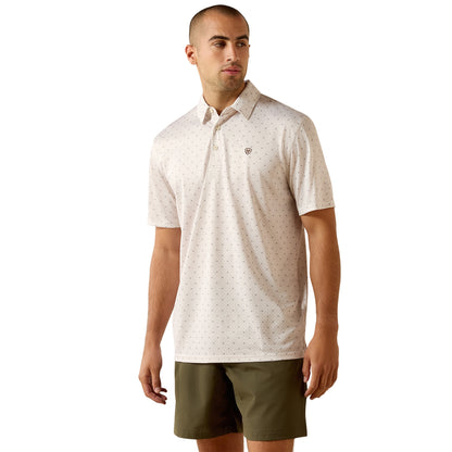 Man wearing a patterned polo shirt and green shorts on a white background