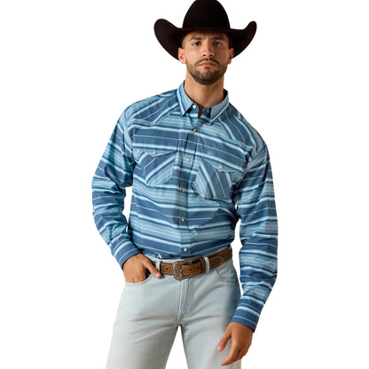 Man wearing a blue patterned shirt, light jeans, and a cowboy hat on a white background